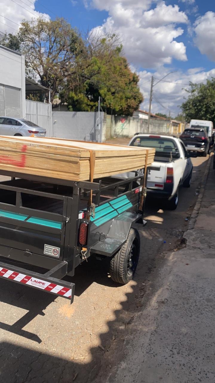 Transporte de painéis de madeira na carretinha